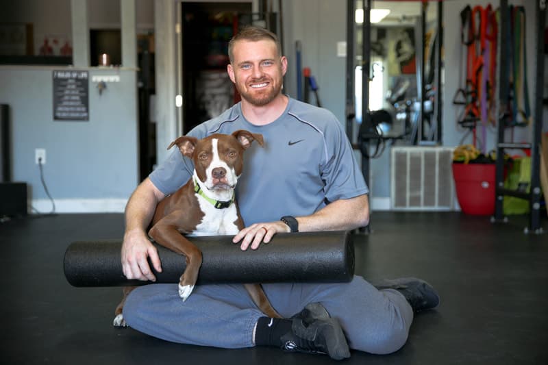 Trey Tucker with his dog Red inside PowerHouseATX